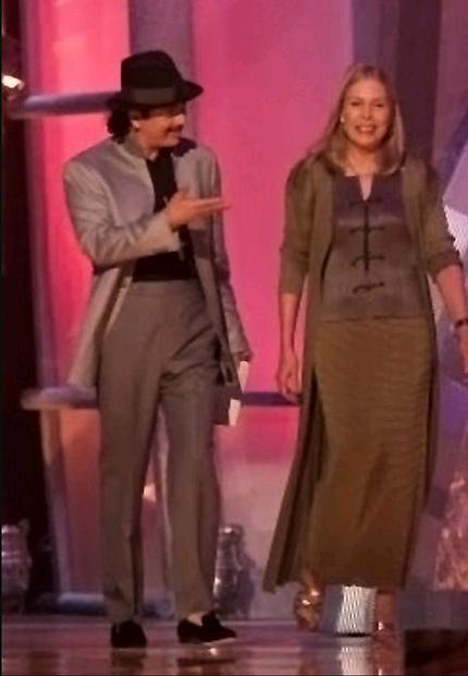 Carlos Santana and Joni walk on stage to present the <i>Record of the Year</i> award.<br>  Photo by Dave Hogan. 