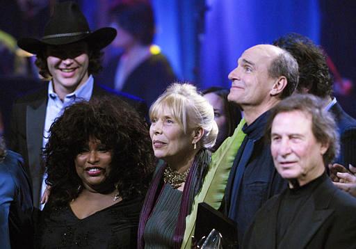 Joni Mitchell (centre) stands with James Taylor (second right) and Chaka Khan (lower left) after being inducted to the Canadian Songwriters Hall of Fame Gala in Toronto. Aaron Harris/CP