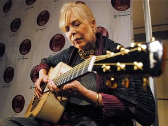 Joni plays a guitar presented to her by guitar makers Robin and Claude Boucher.