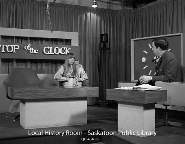 Joni on the set of CFQC-TV noon show <i>Top Of The Clock</i> speaking to host Verne Prior.  Photo by CFQC staff. 