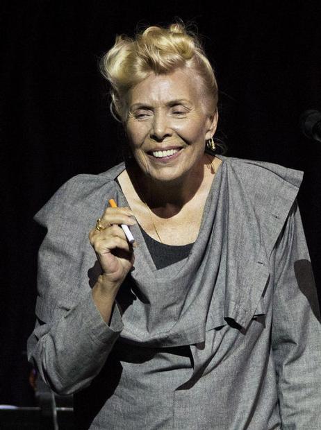 Joni Mitchell smokes an electronic cigarette on stage during her 70th birthday tribute concert as part of the Luminato Festival at Massey Hall in Toronto on Tuesday June 18, 2013. AARON VINCENT ELKAIM / THE CANADIAN PRESS 